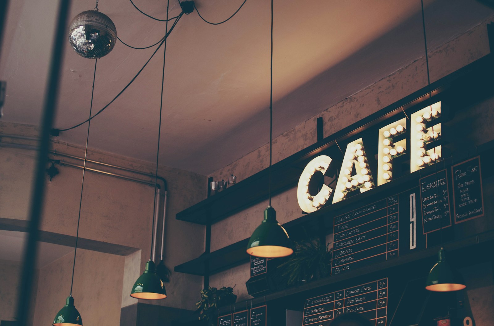 Coffee and pastries on a café counter in warm daylight