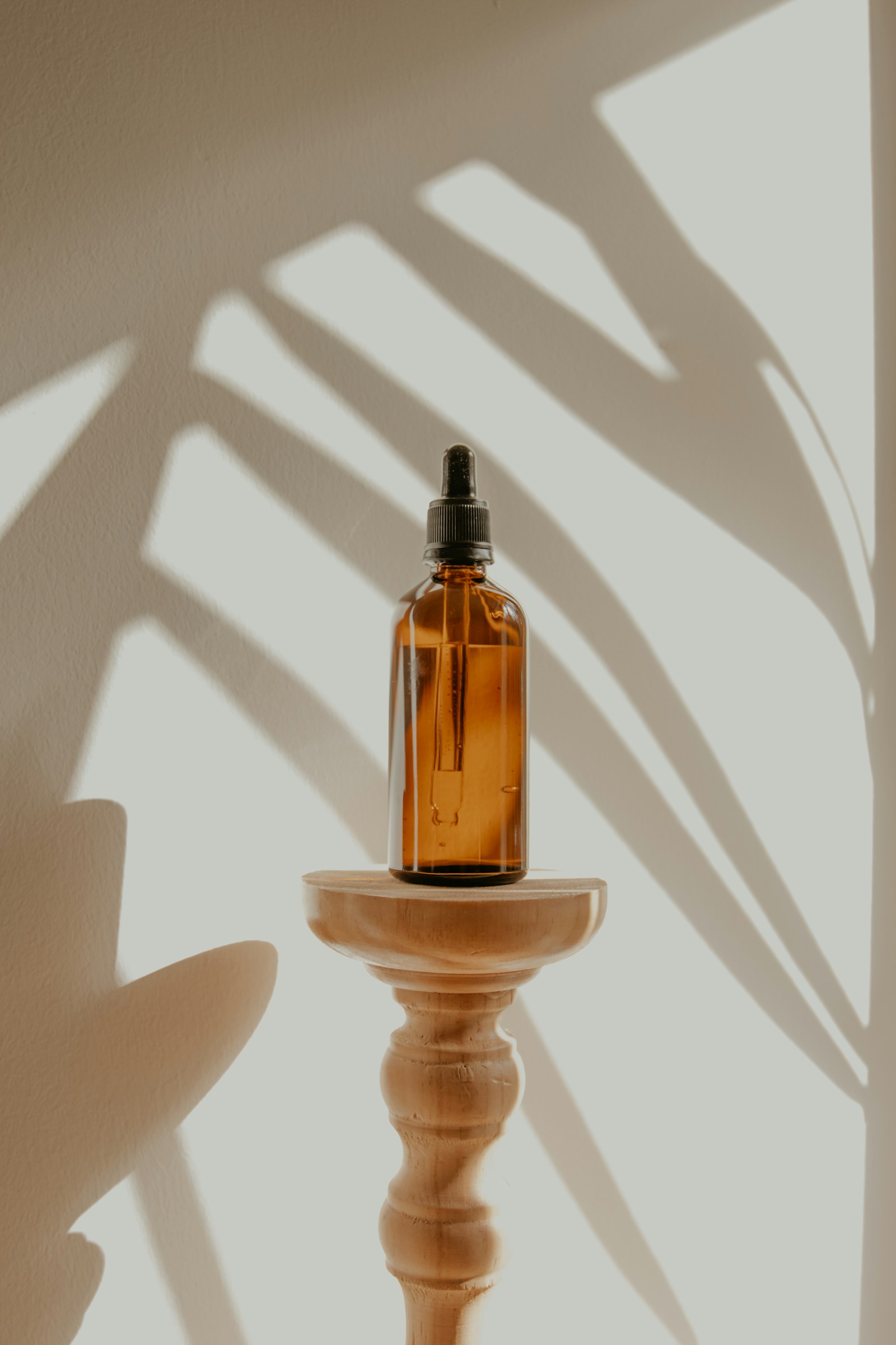 Amber glass skincare bottle in warm sunlight