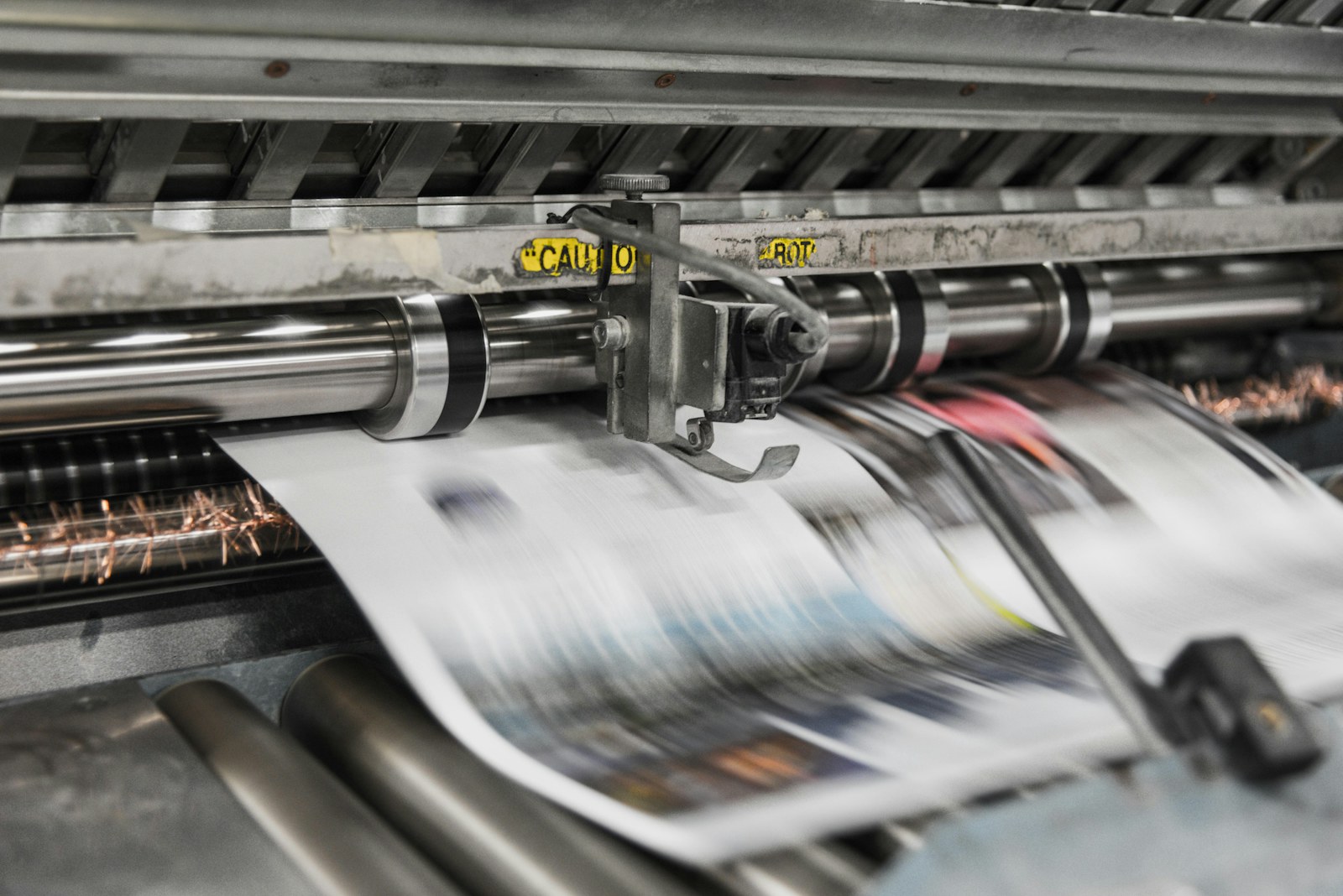 Printing press in motion, representing the studio's craft-led approach