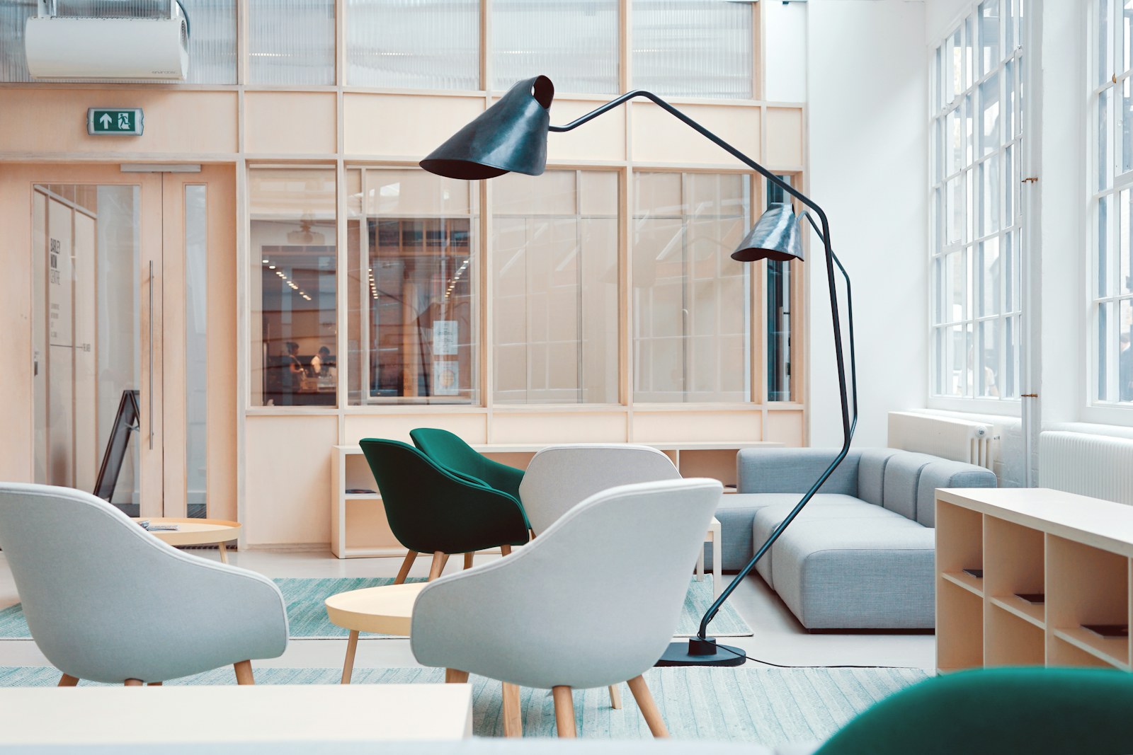A warm, light-filled studio lounge with mid-century furniture and plants